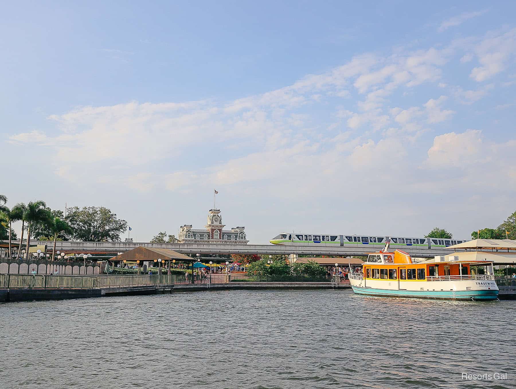 the monorail and a boat docked in front of Magic Kingdom 