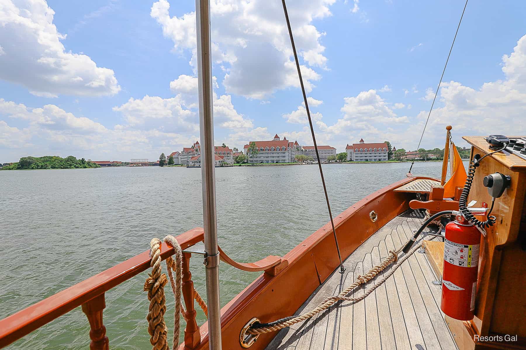 a boat sailing across Seven Seas Lagoon on its way to Grand Floridian 