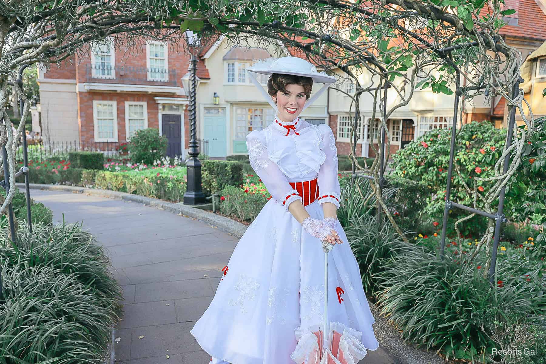 Mary Poppins poses with her umbrella. 