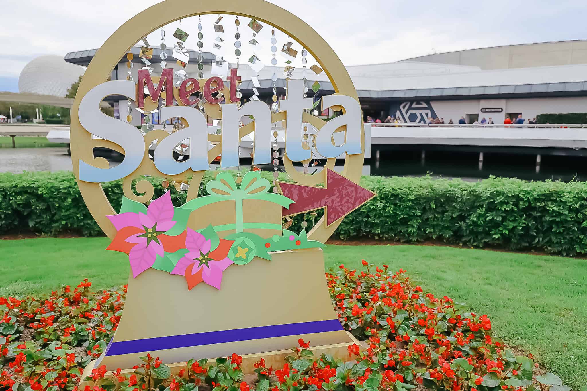 a sign at Epcot with a directional to Meet Santa 