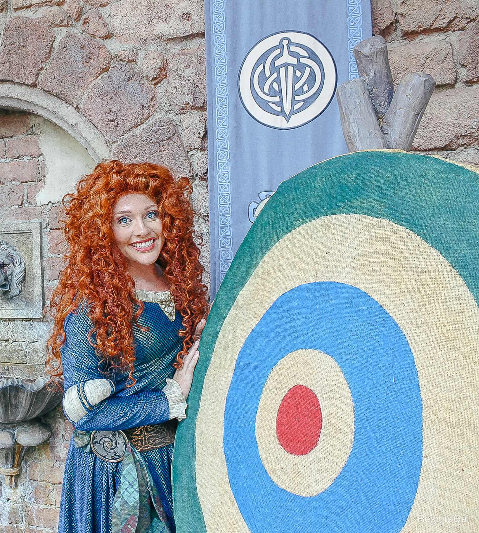 Merida poses by a target 