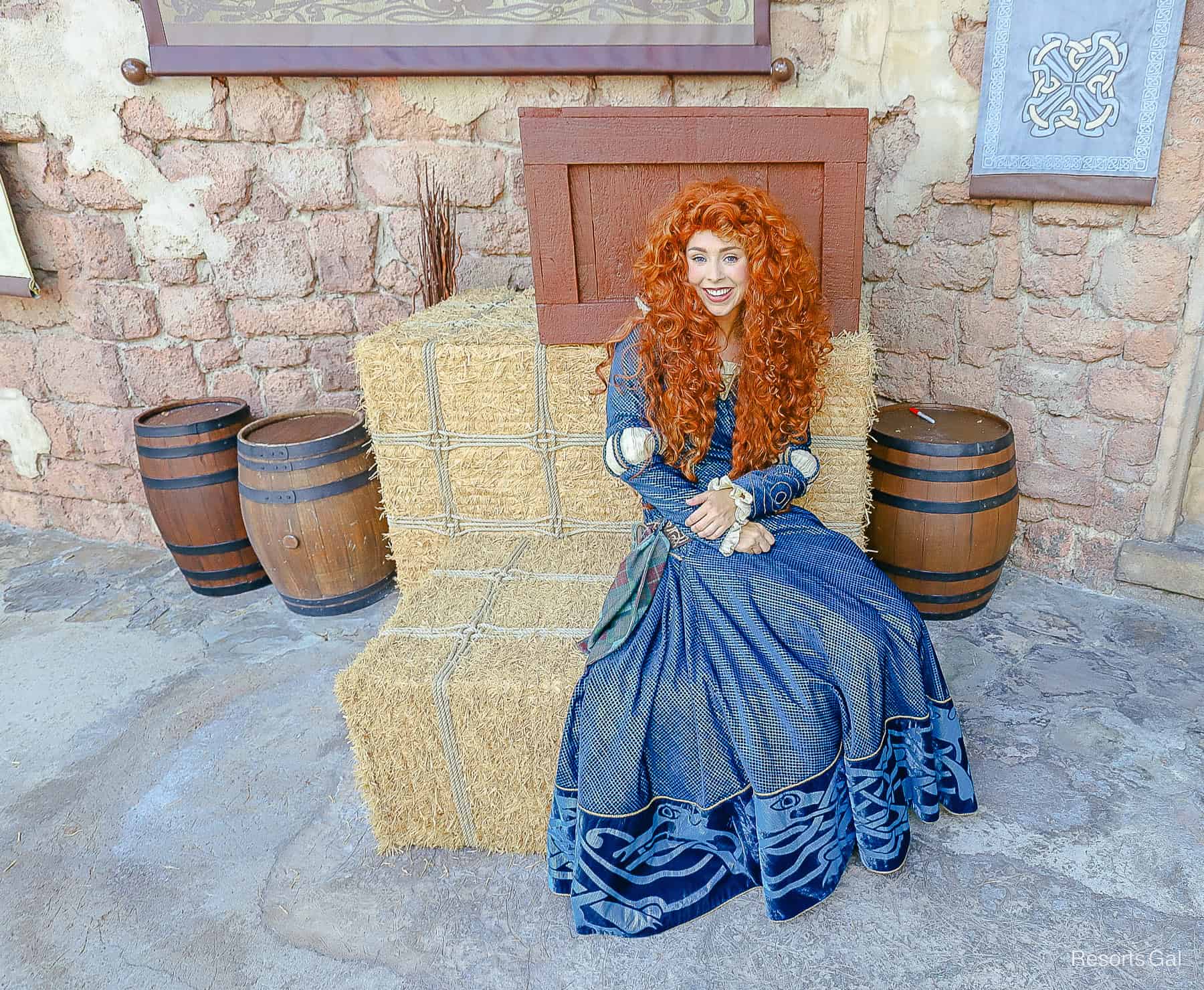 Merida sitting on for a picture at Fairytale Gardens at Magic Kingdom