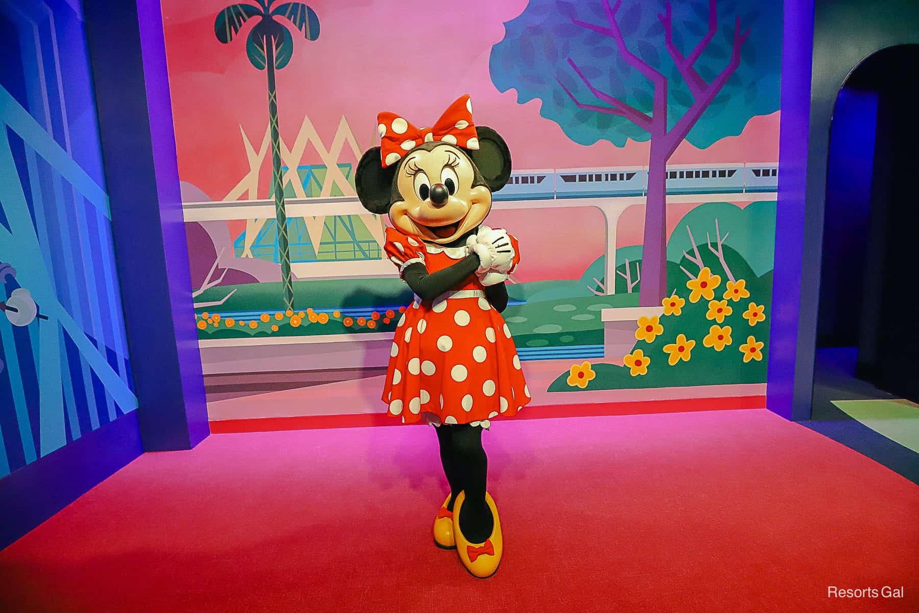 Minnie Mouse is wearing her red dress with white polka dots and yellow shoes with red bows. 