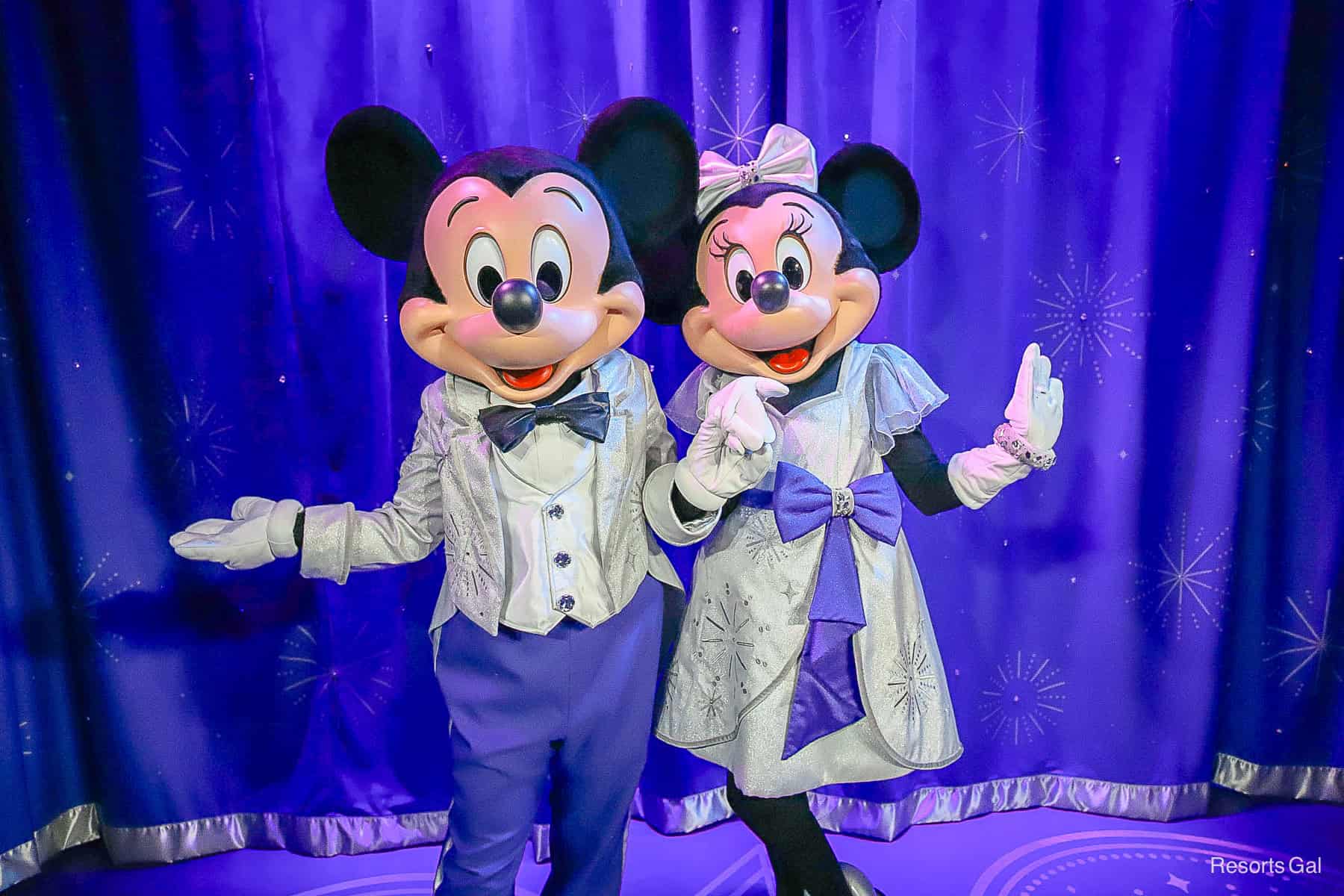 Mickey and Minnie Mouse wearing silver outfits for the Disney 100 celebration. 