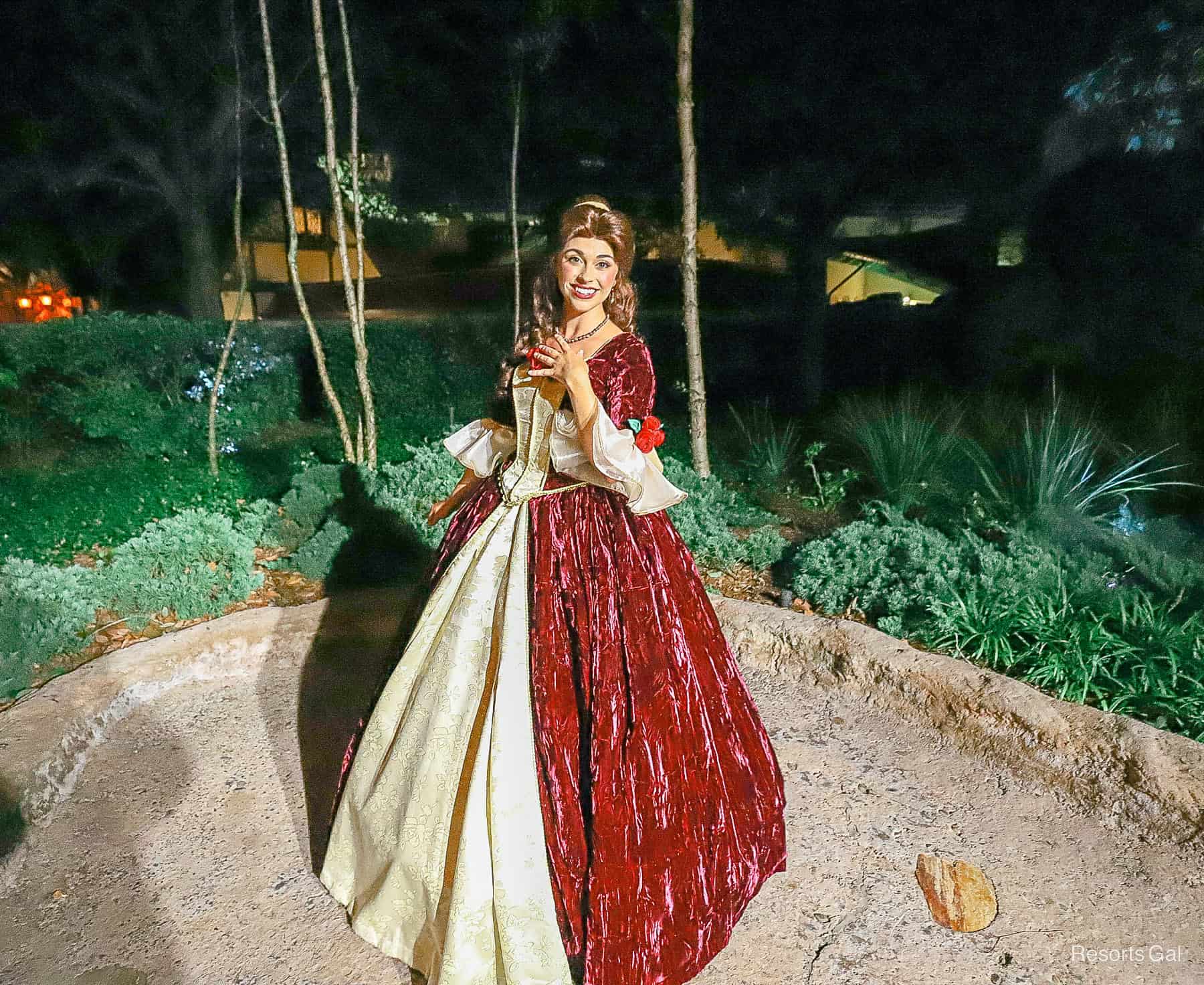 Belle in her holiday gown with red velvet and gold trim during Mickey's Very Merry Christmas Party. 