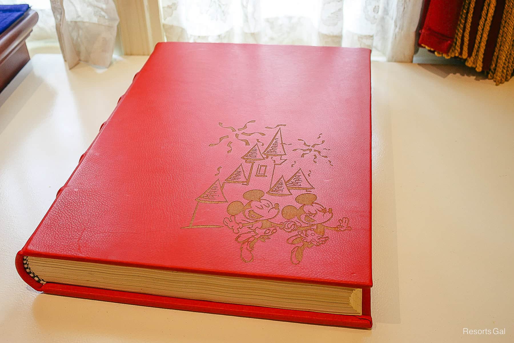 guest book for guests to sign during Mickey and Minnie's 90th birthday party 