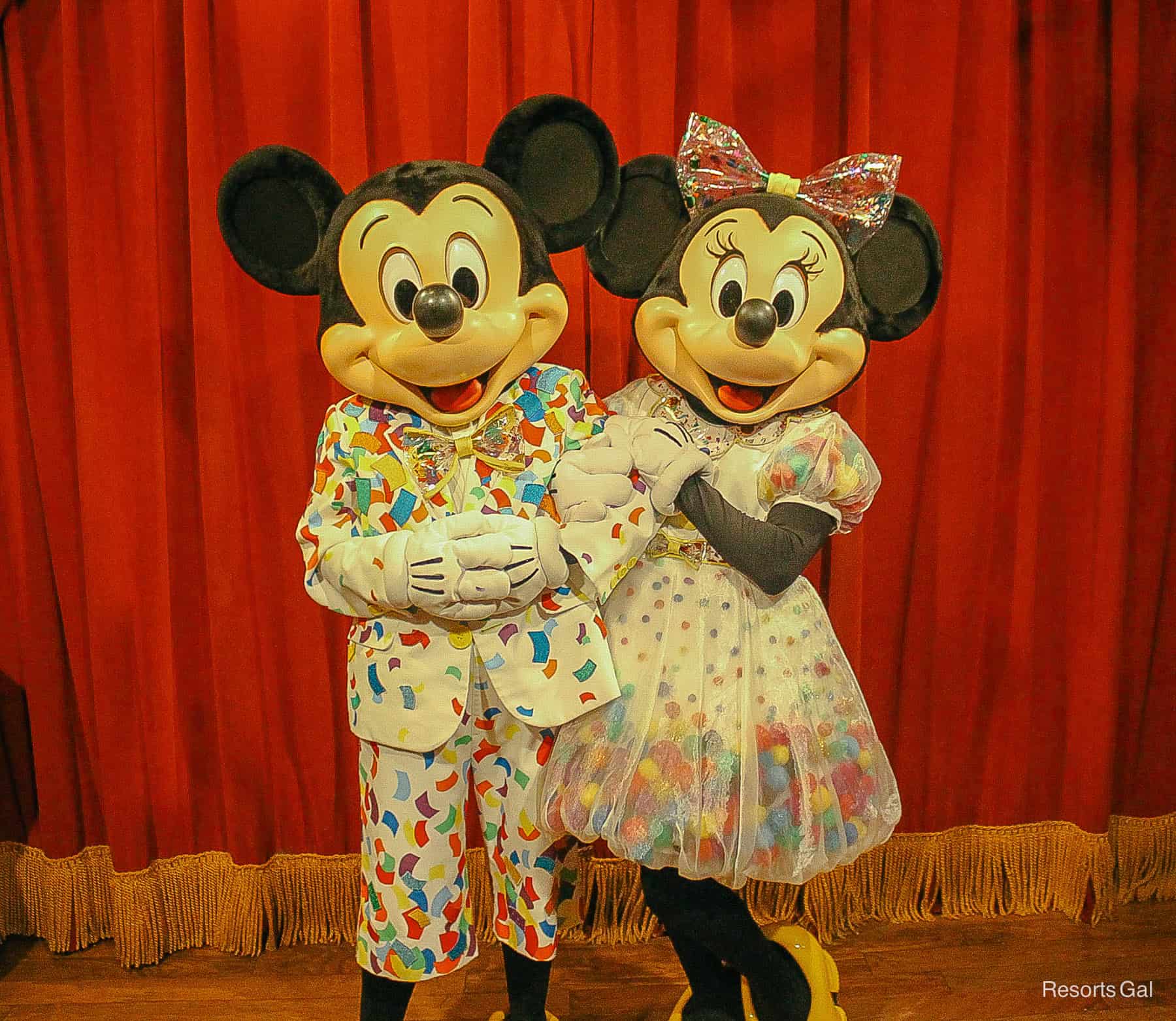 Mickey and Minnie Mouse in their confetti 90th birthday outfits. 