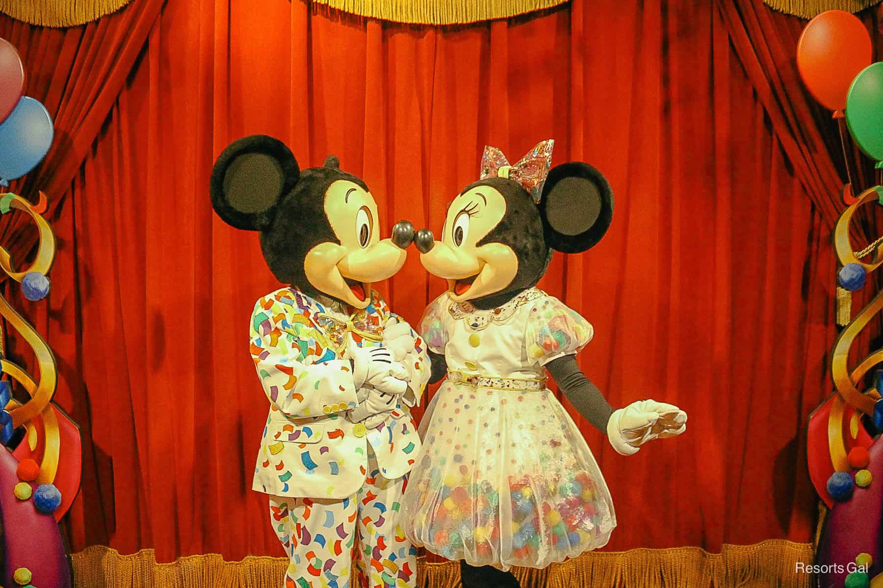 Mickey and Minnie share a nose kiss. 