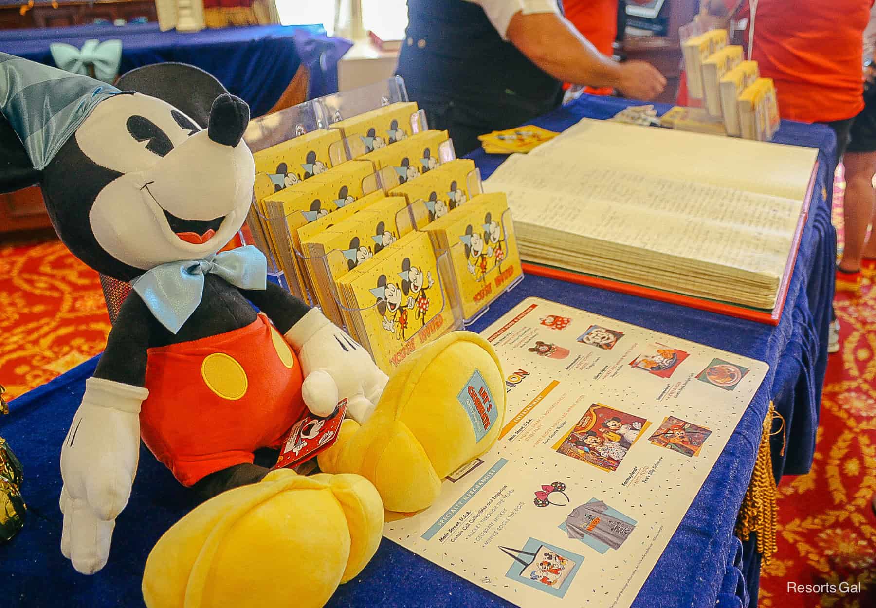 a stuffed Mickey birthday doll and a guest book 