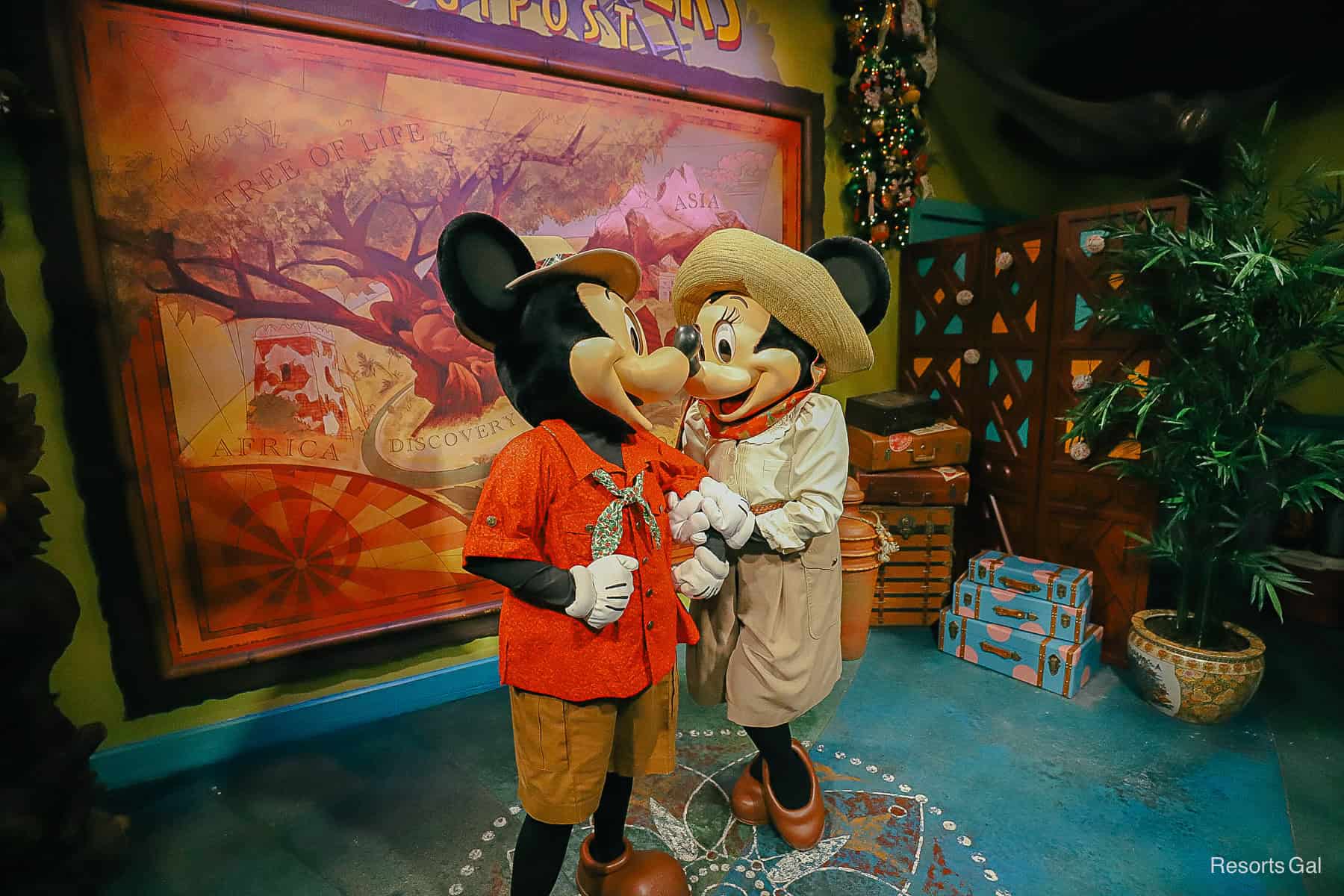 Mickey and Minnie Mouse nuzzle for a photo in their Christmas look at Adventurer's Outpost. 