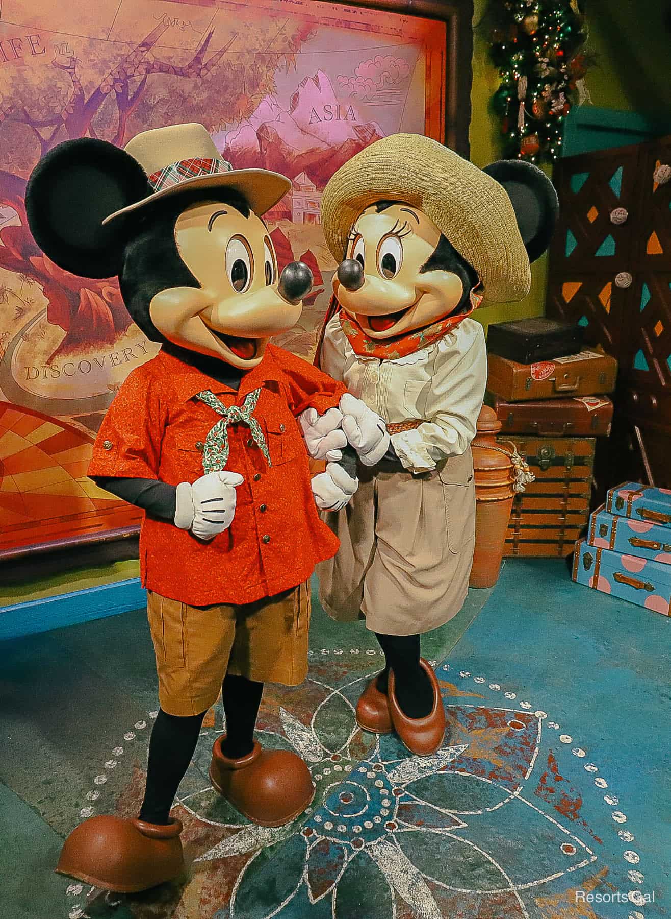 Mickey and Minnie Mouse wearing holiday Christmas outfits mixed with safari suits 