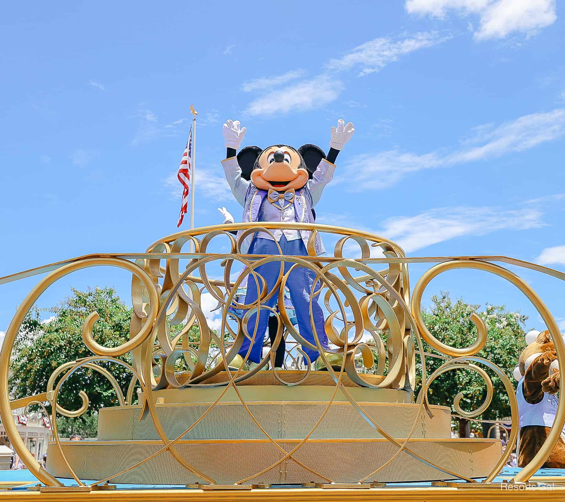 Mickey with both hands up in the air like it's a celebration. 