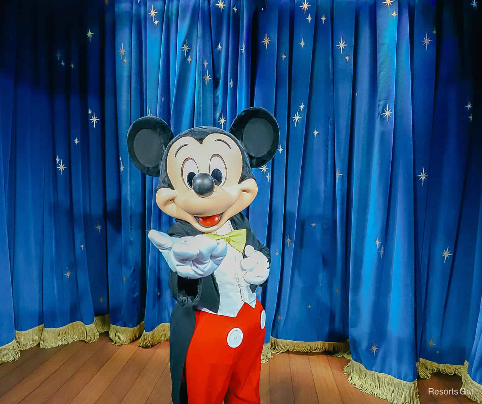 Mickey Mouse with hand extended.