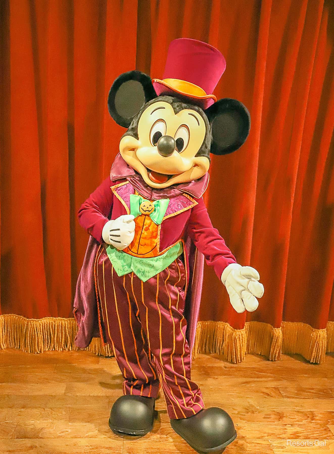 Mickey Mouse in a purple Halloween costume with pumpkin shirt 