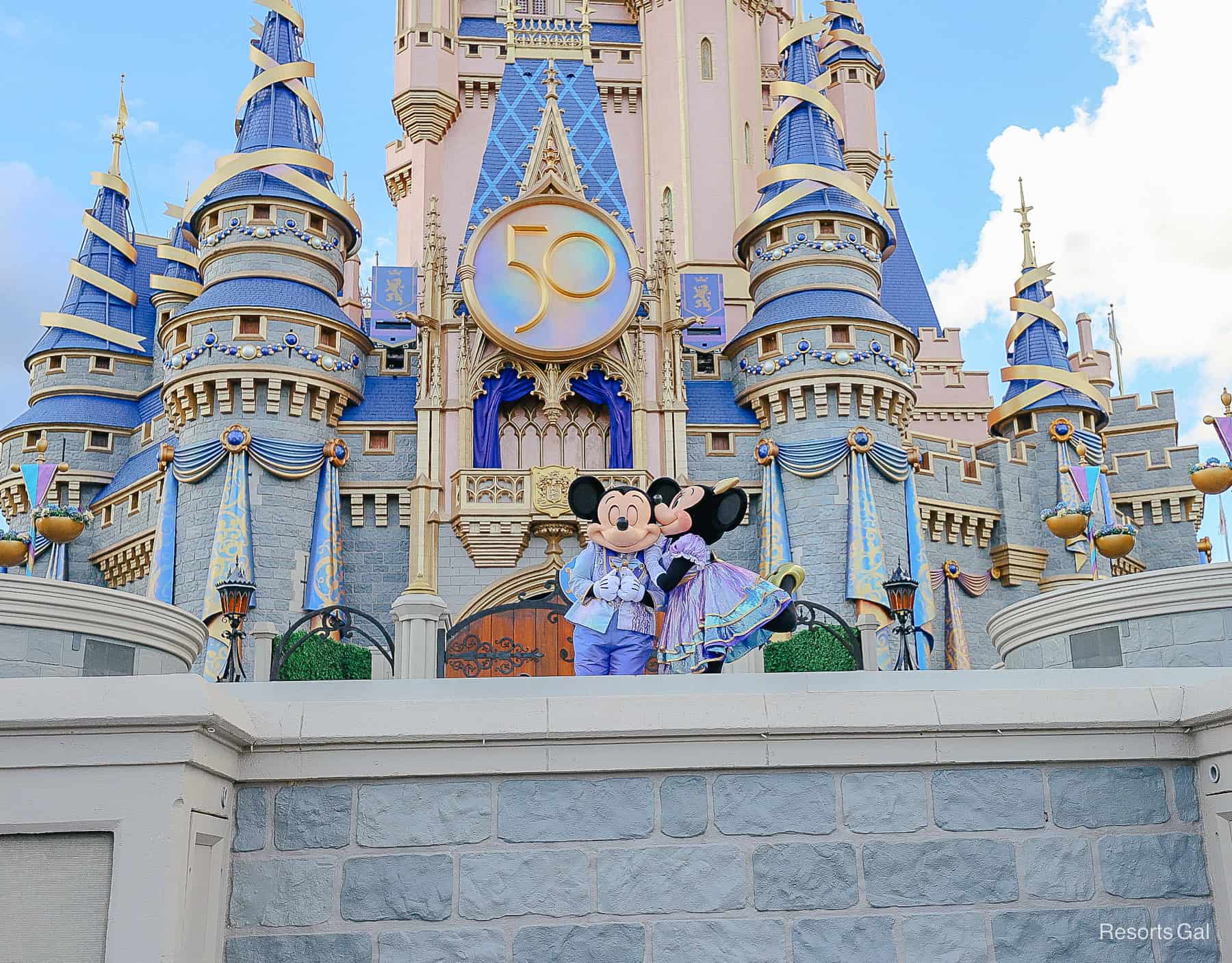 Minnie gives Mickey a kiss on the cheek during the 50th anniversary 