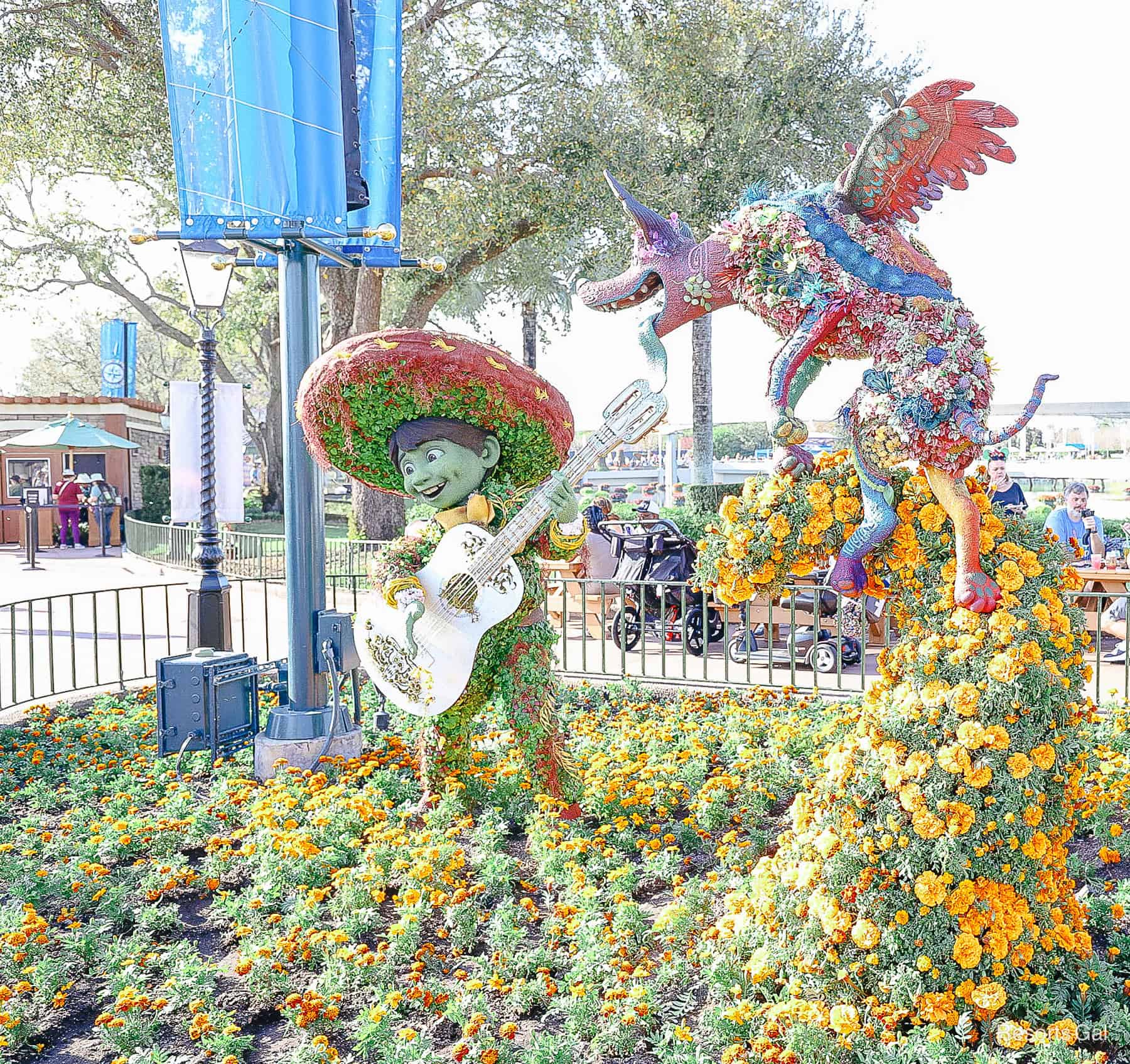 Miguel and Dante outside the Mexico Pavilion in topiary form 