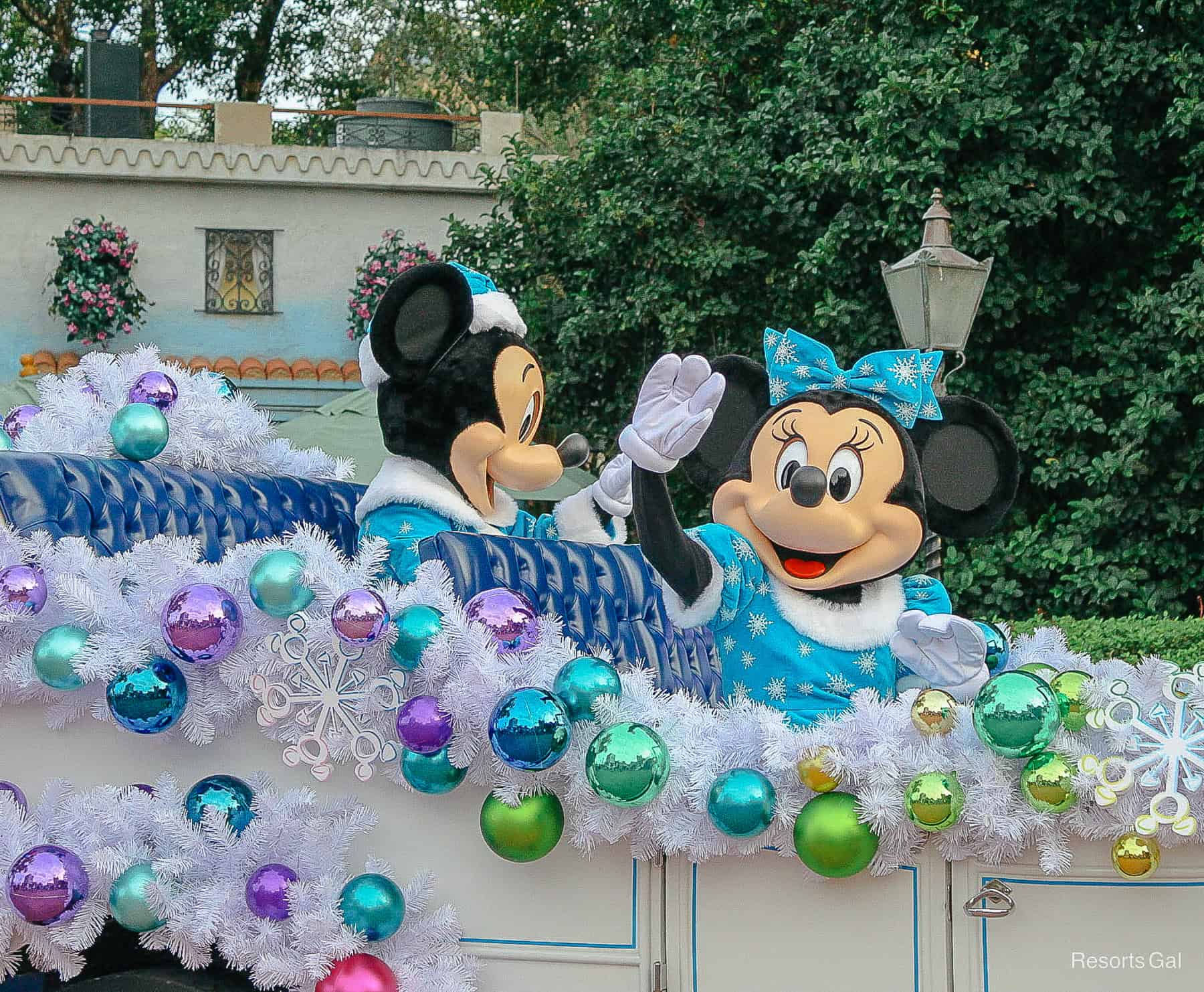 Minnie waves from a seasonal promenade at Epcot during social distancing. 