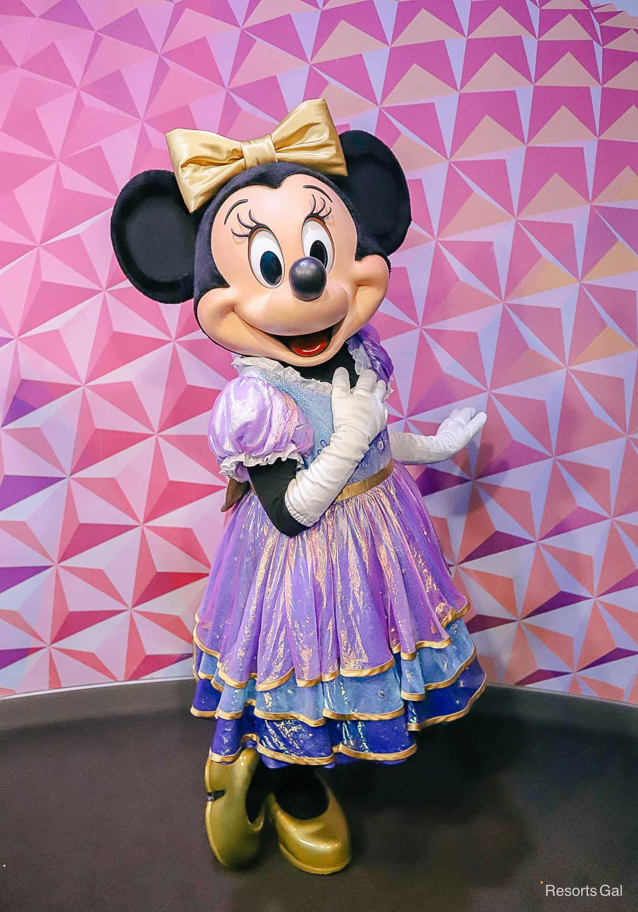 Minnie Mouse in her Earisdescent dress with gold bow. 