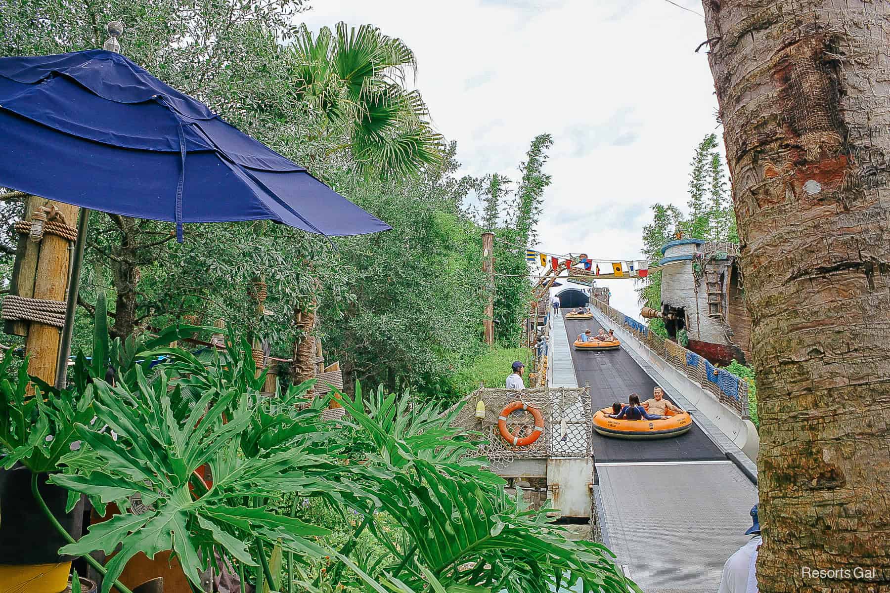 guests riding the conveyor belt to the top of Miss Adventure Falls 