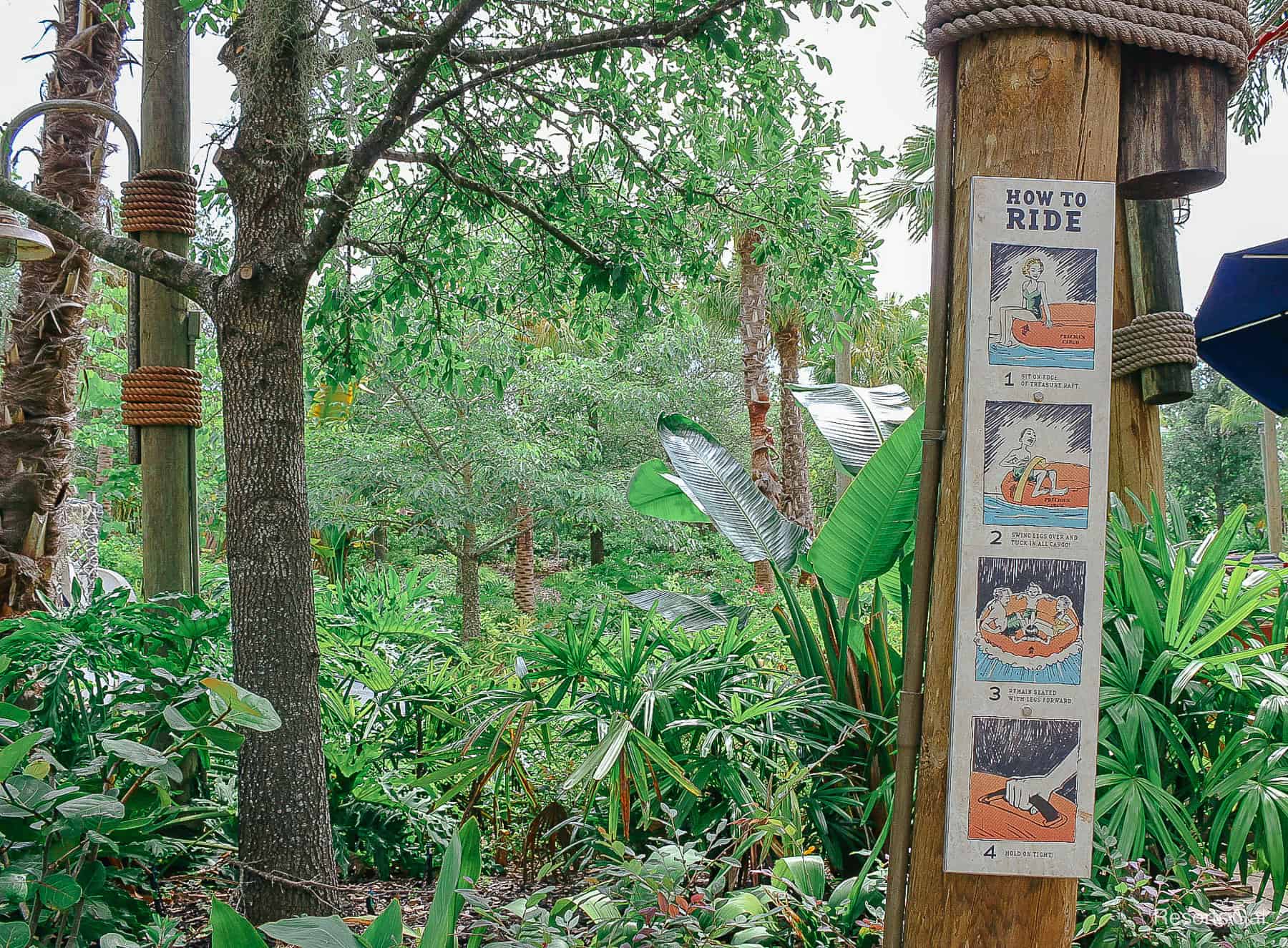 a long sign with photos showing examples of how to board the rafts for Miss Adventure Falls 