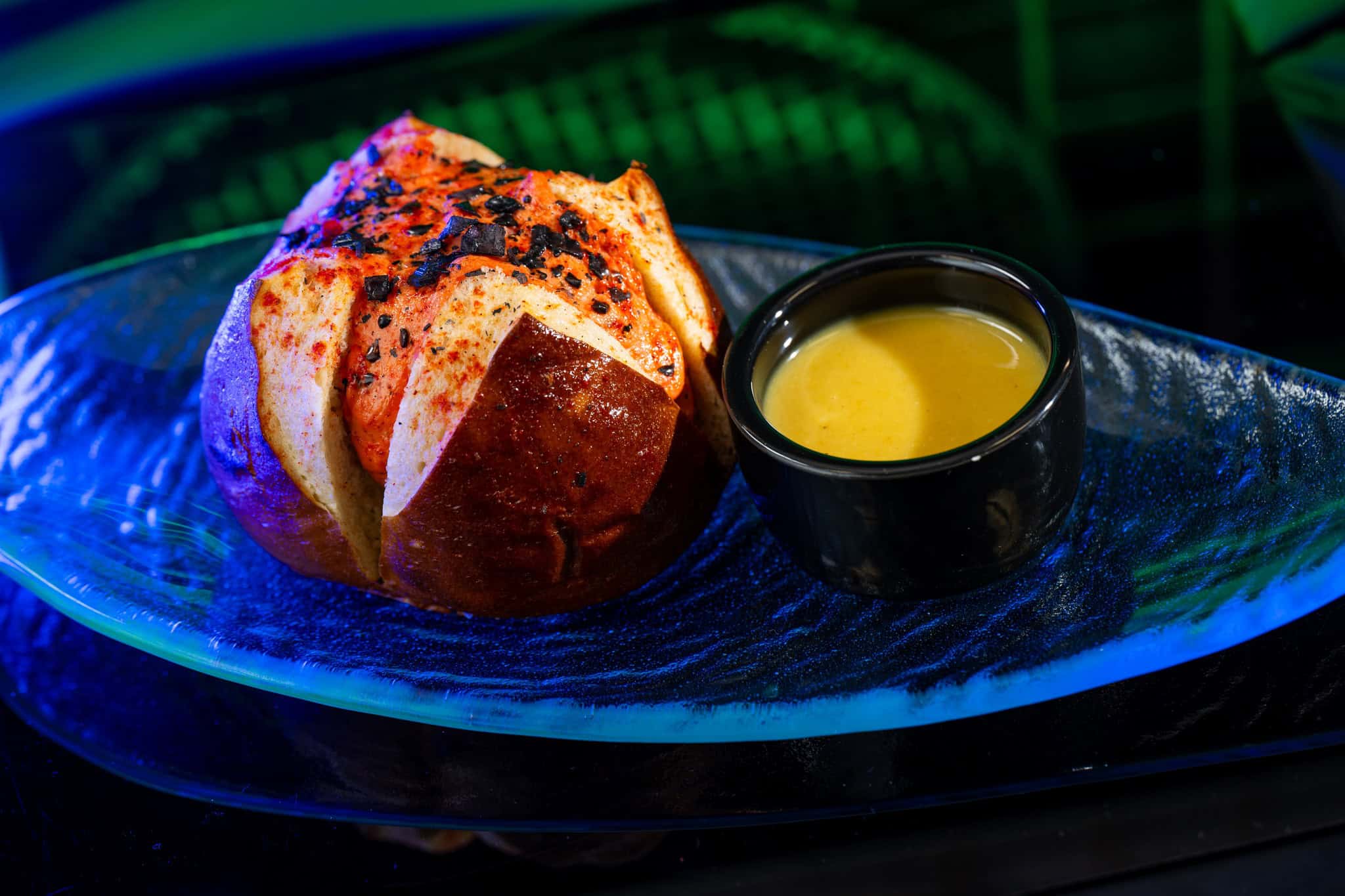 Umbaran Cheese Roll: Spice-dusted pretzel bun stuffed with herbed cheese and a dipping sauce 