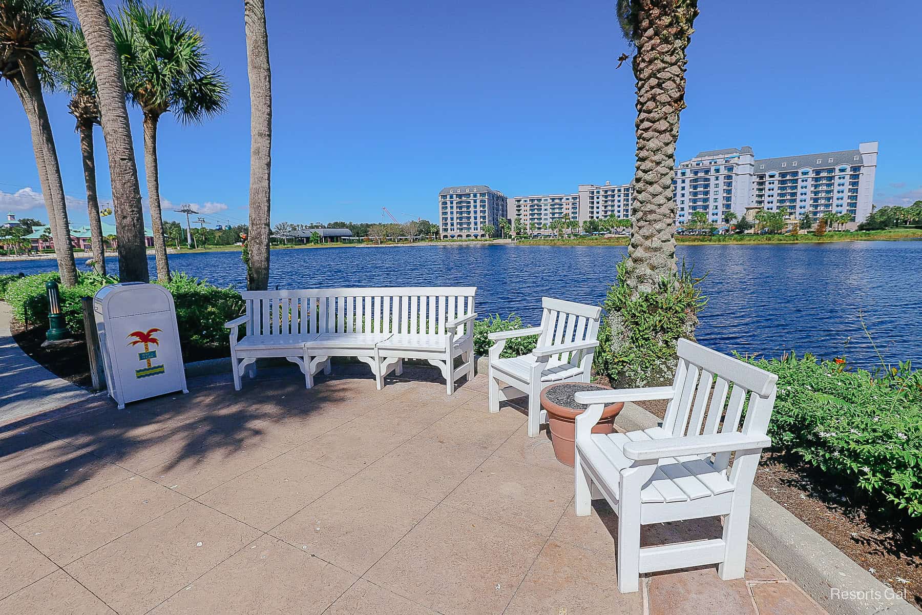 a bench with two chairs near the lake facing Disney's Riviera 