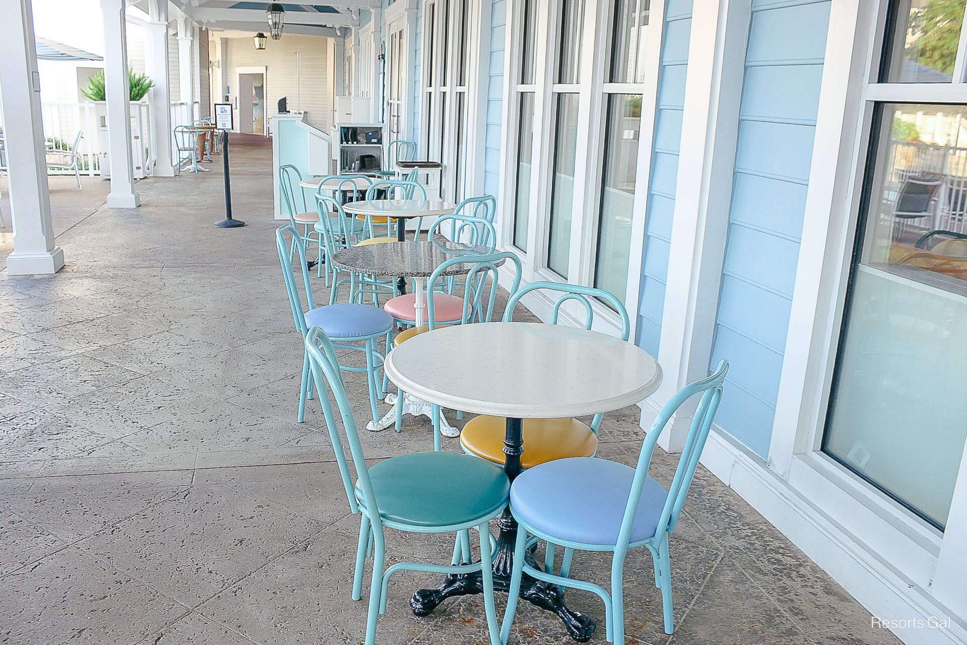 small sets of tables with three chairs in pastel colors 