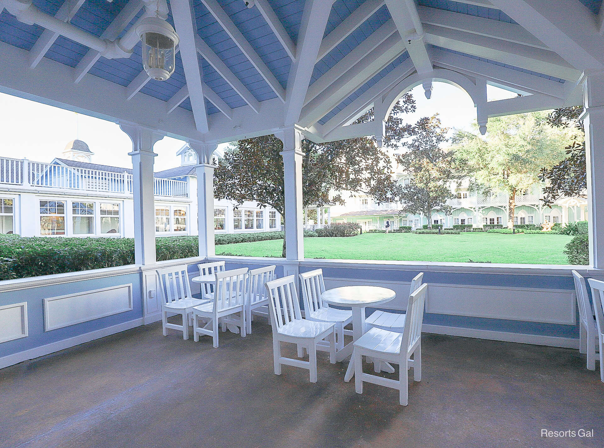 a covered outdoor dining area with tables and chairs 