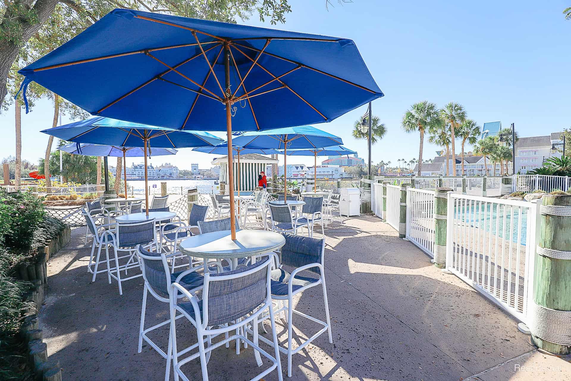 a grouping of raised counter height tables and chairs near Crescent Lake 