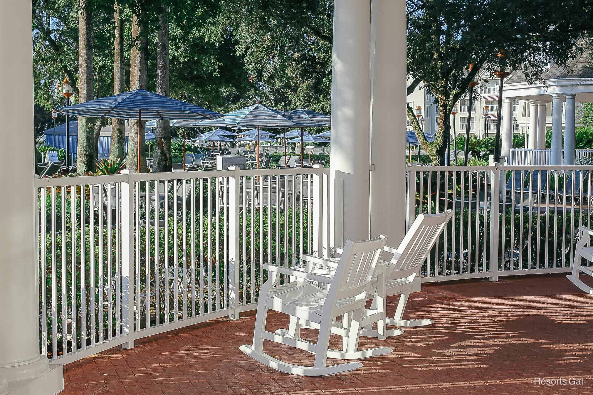 two rocking chairs that face the pool area at the Yacht Club 