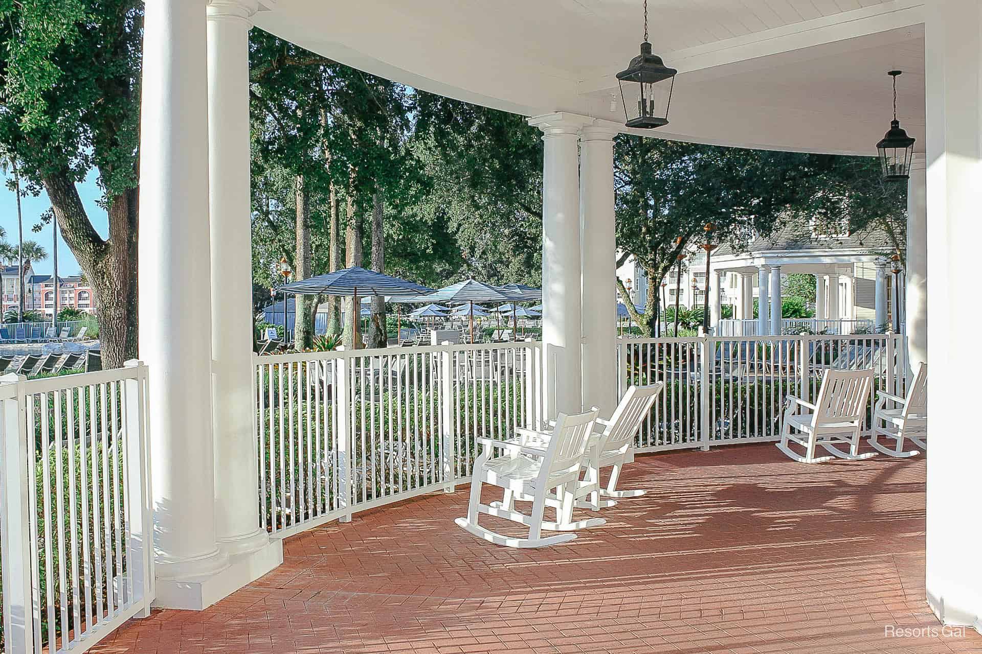 a patio with rocker and chairs between them 