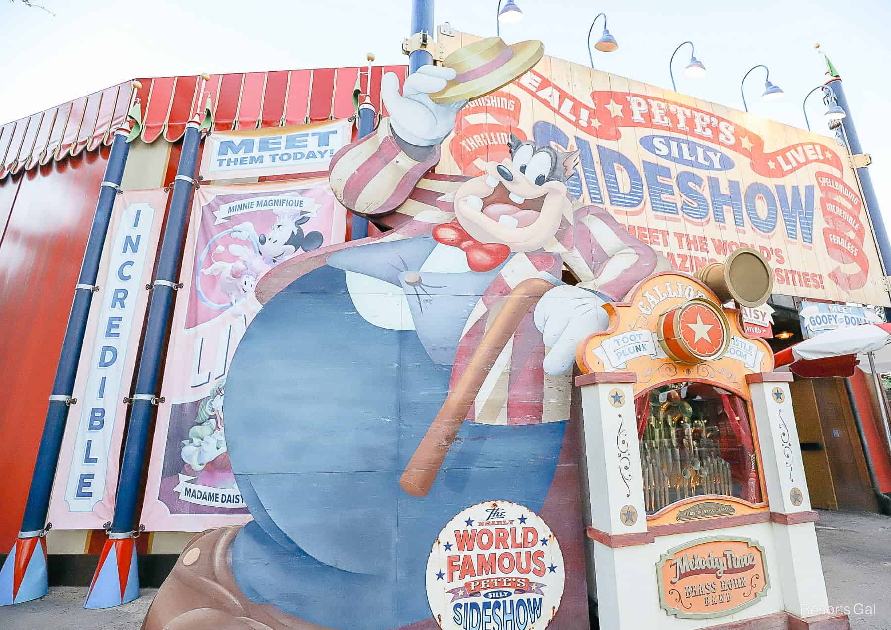 a giant Pete tips his hat to guests entering his sideshow 