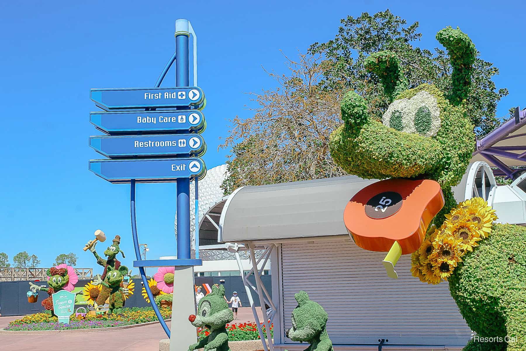 shows how Pluto's topiary is only a few feet away from Mickey, Minnie and Goofy 