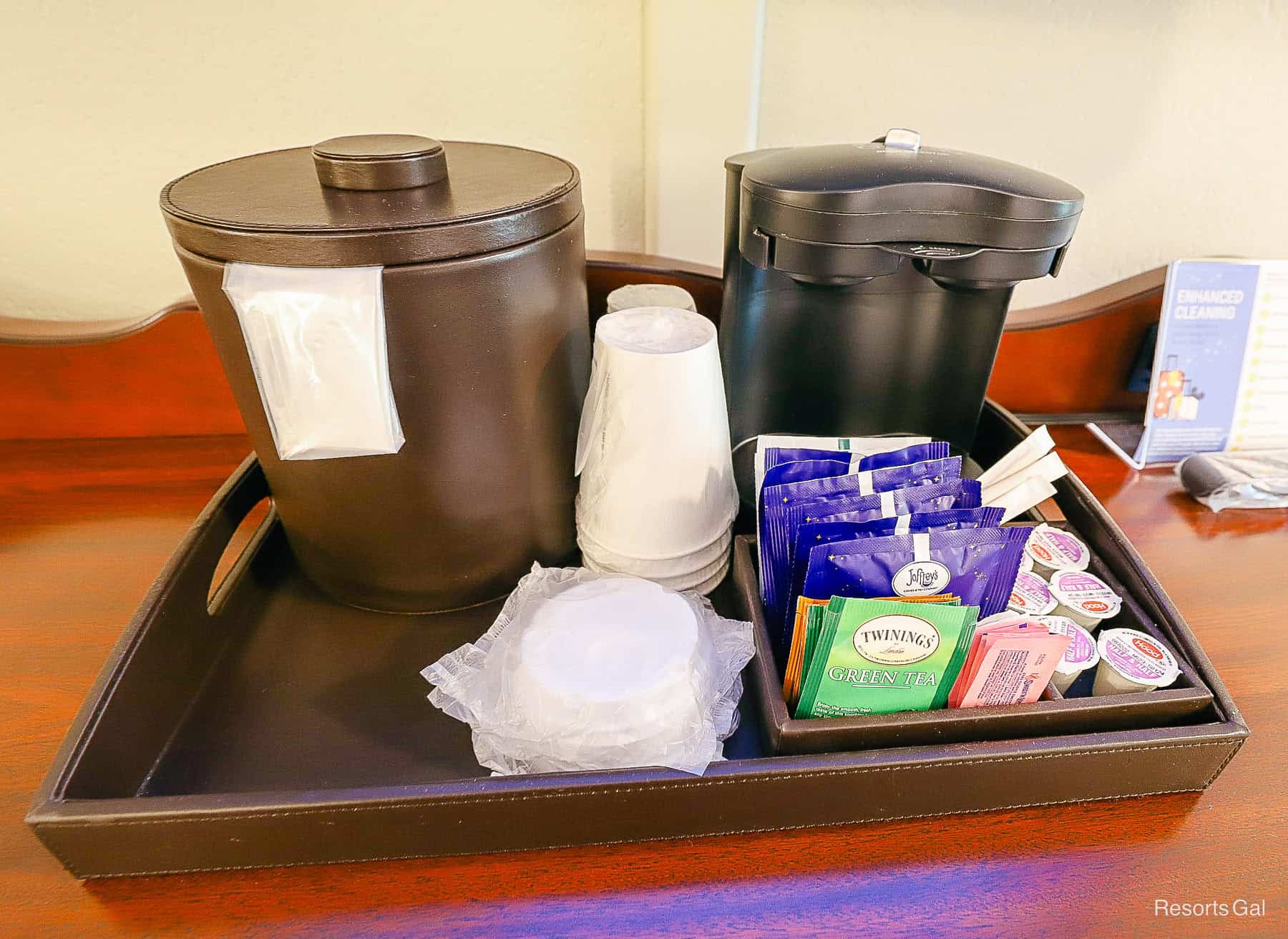 the individual cup coffee maker and coffee options, cups, creamer in the room at Port Orleans French Quarter 