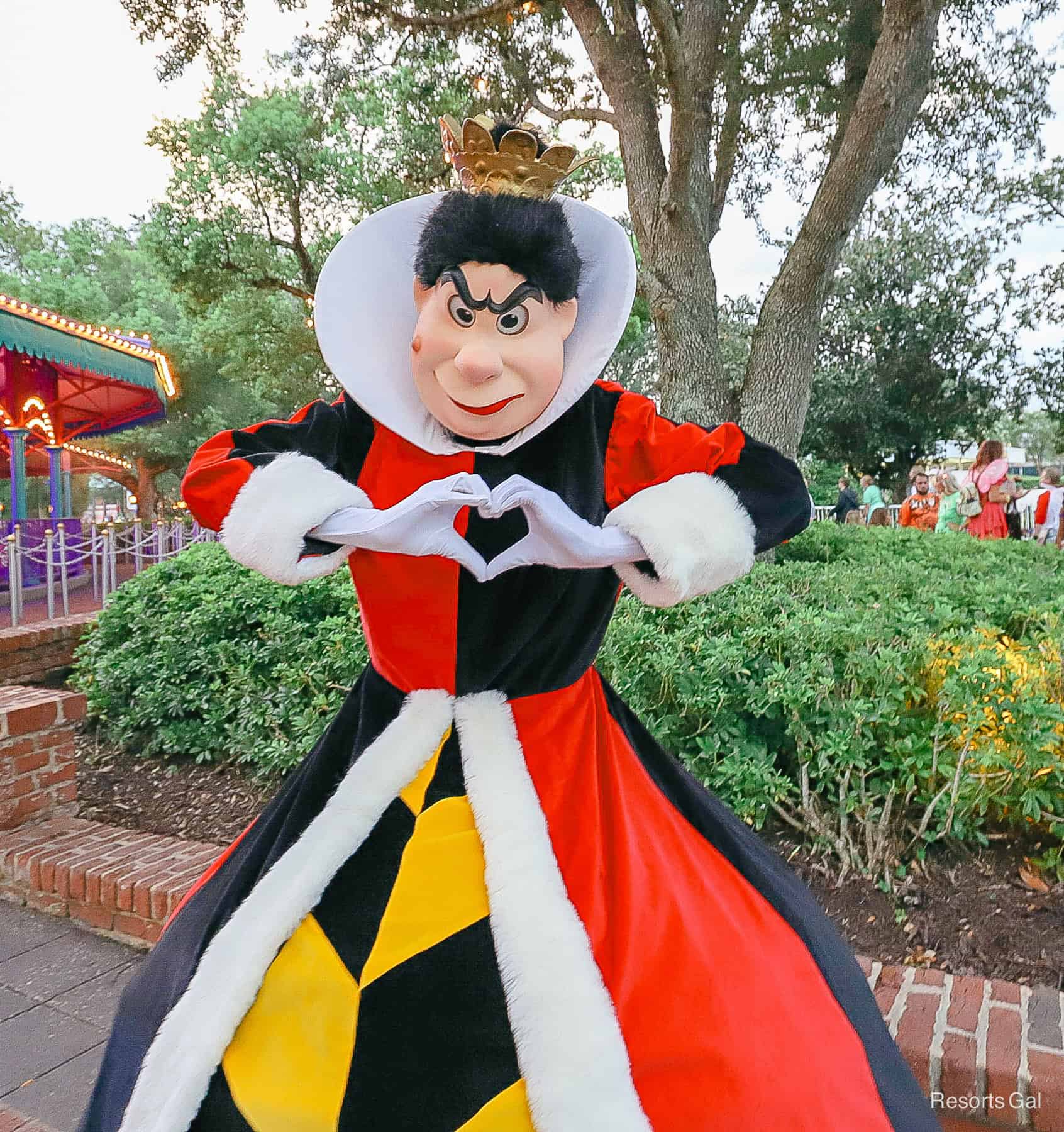 Queen of Hearts with her hands in a heart pose