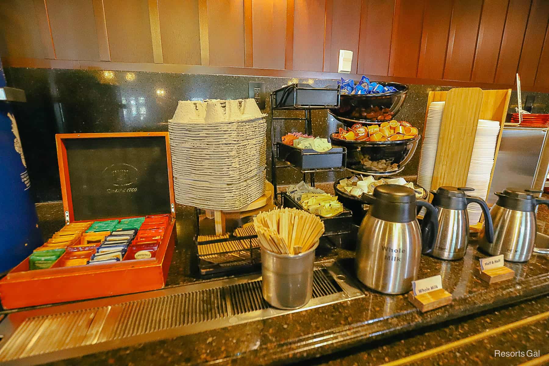 a display of creamers, milk, coffee stirrers, and tea bags for the coffee at Roaring Fork 