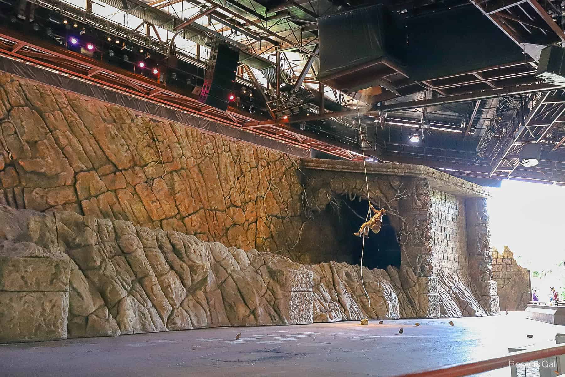 a rope drops from the ceiling and Indiana Jones repels down during the opening act of Epic Stunt Spectacular 