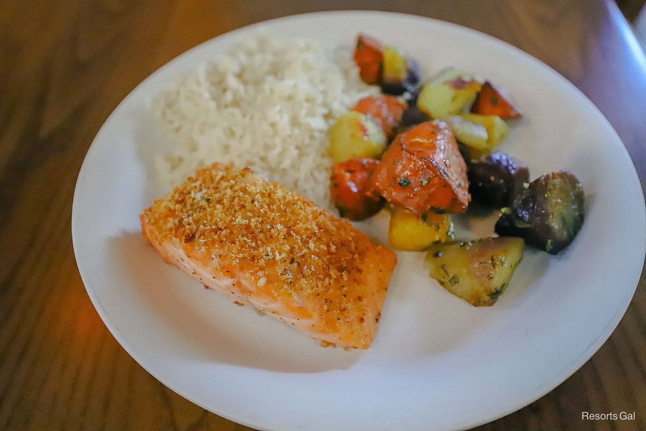 a prepared plate with salmon, carrots, and rice 