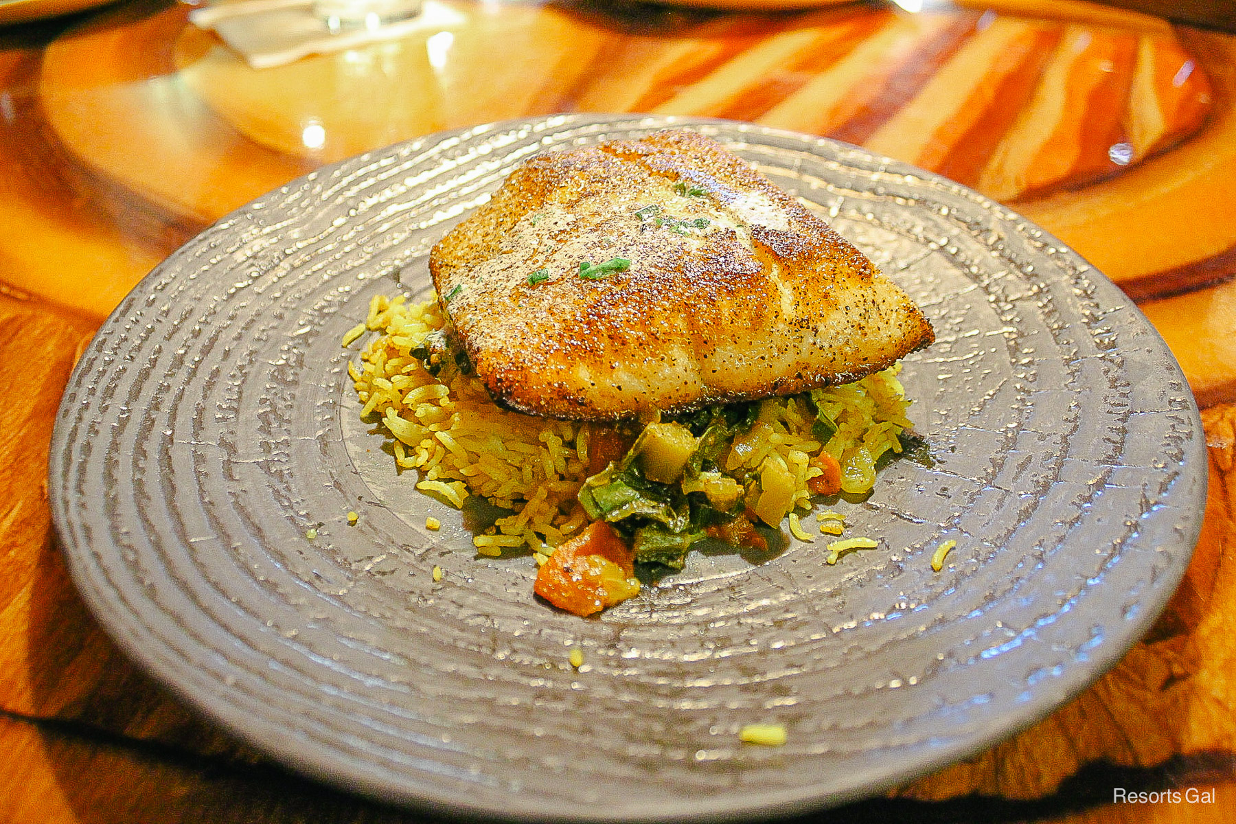 an entree of sustainable fish with vegetables at Sanaa 