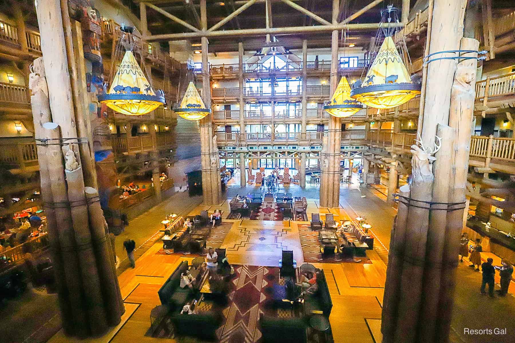 A view from the back of the lobby to the front with unique wood carvings on the combined poles. 