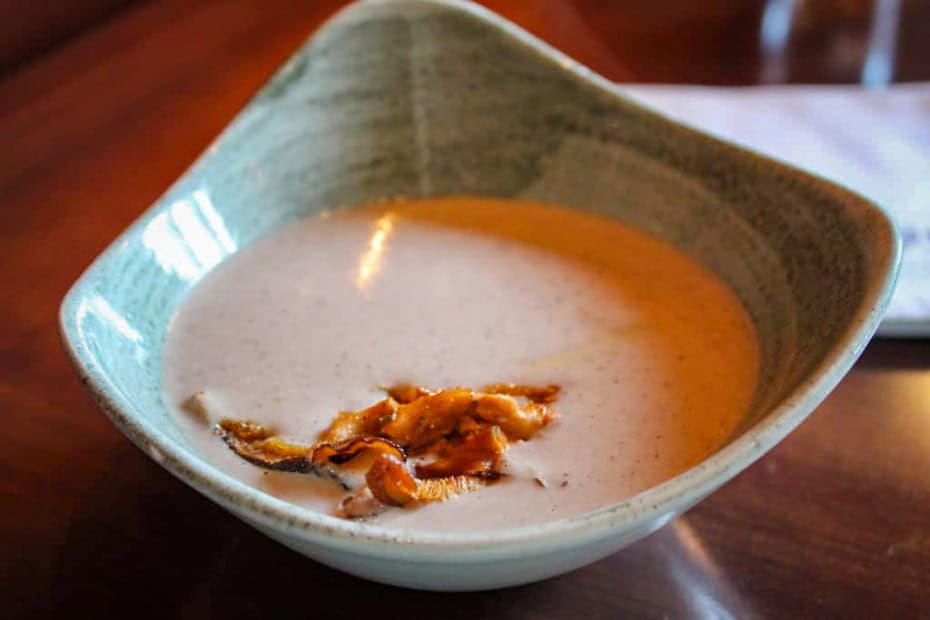 an appetizer of mushroom soup at a signature dining location 