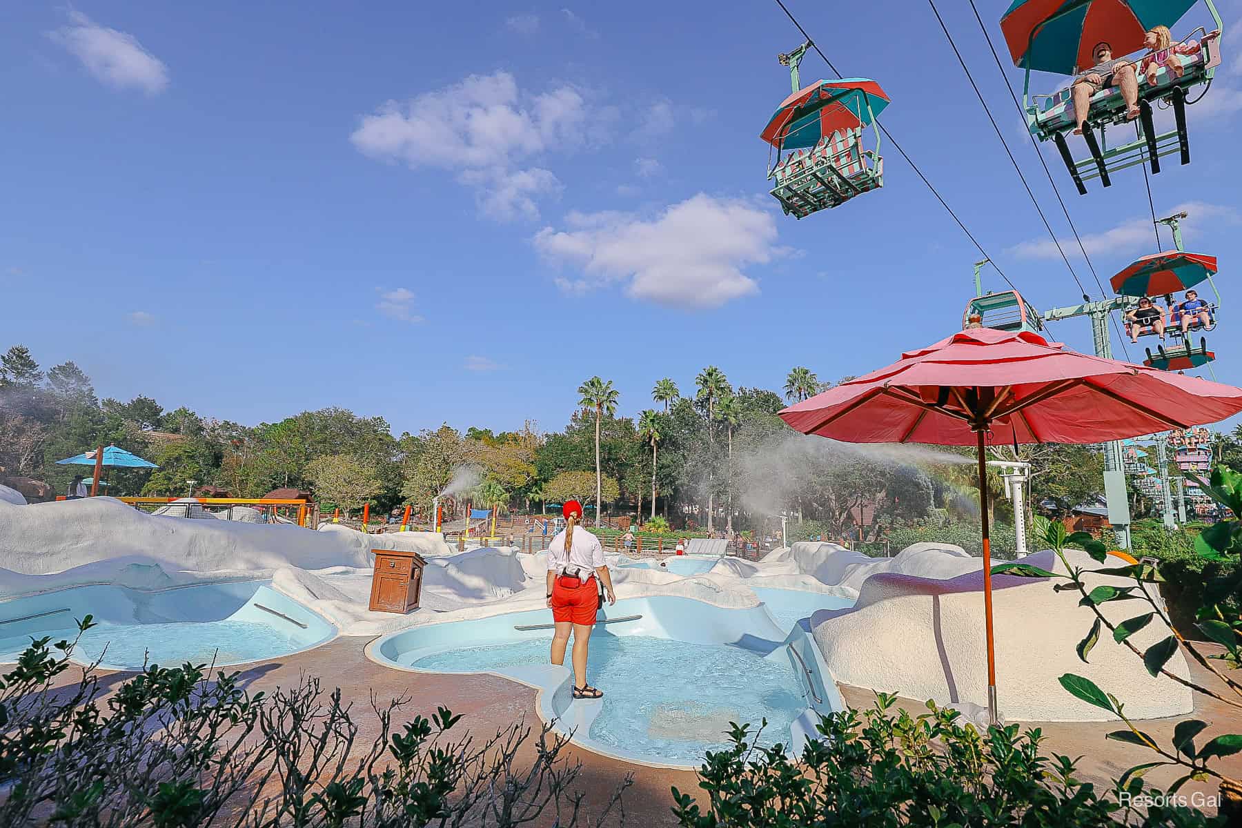 a lifeguard is at the top of the pool area 