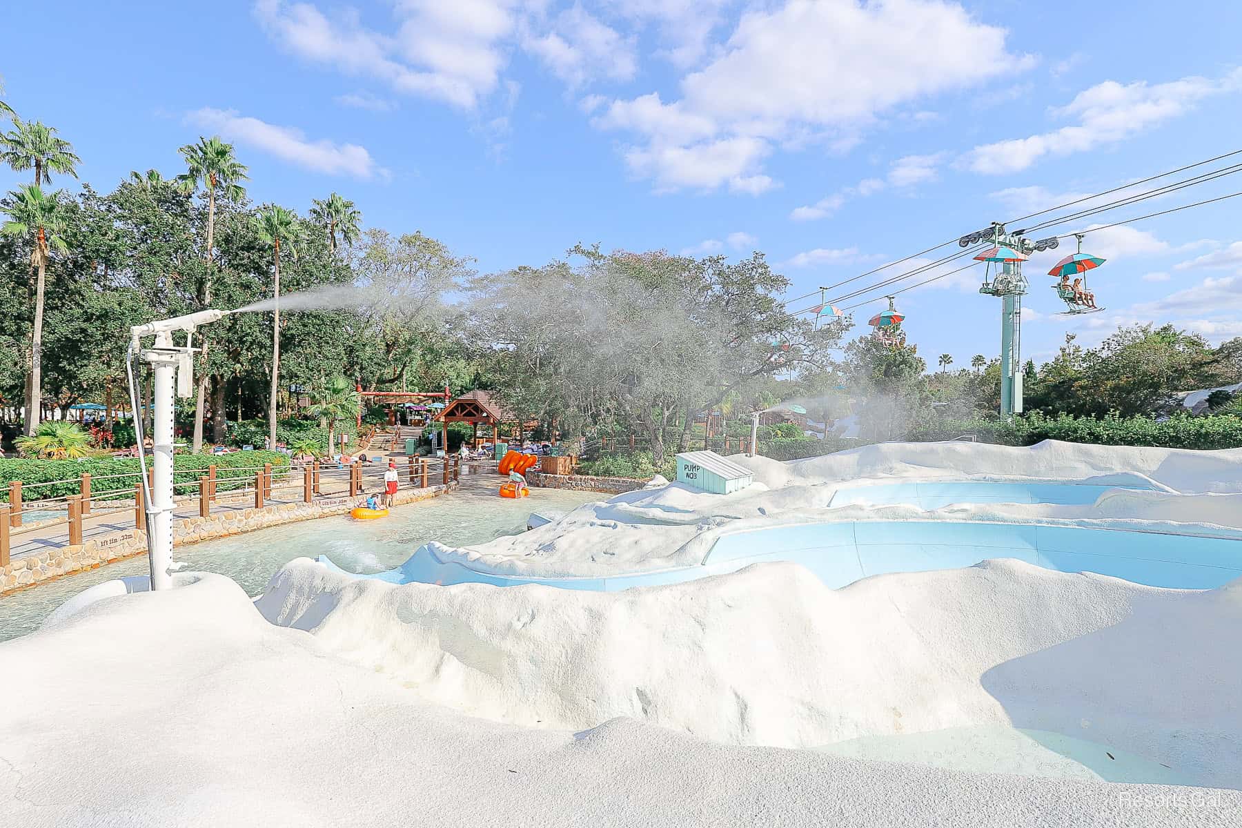 a snow machine sprays a mist of water over the inner tube slides 