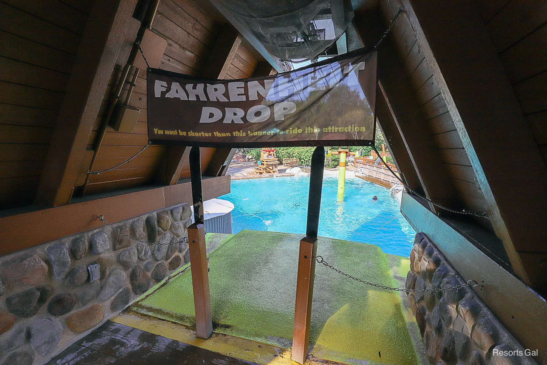 Sign says "Fahrenheit Drop You must be shorter than this banner to ride this attraction." 