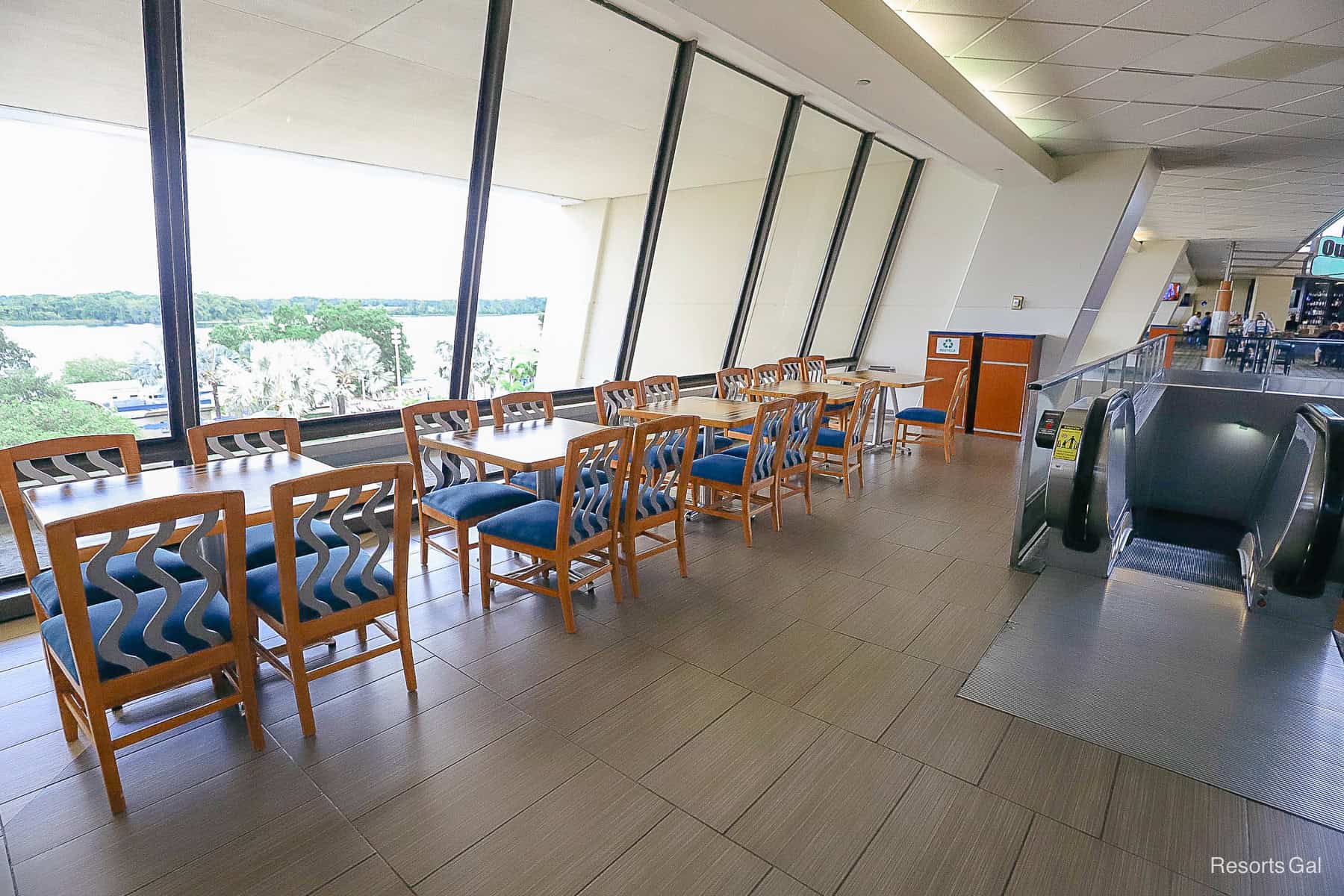 a row of tables and chairs that face Bay Lake at Disney's Contemporary 