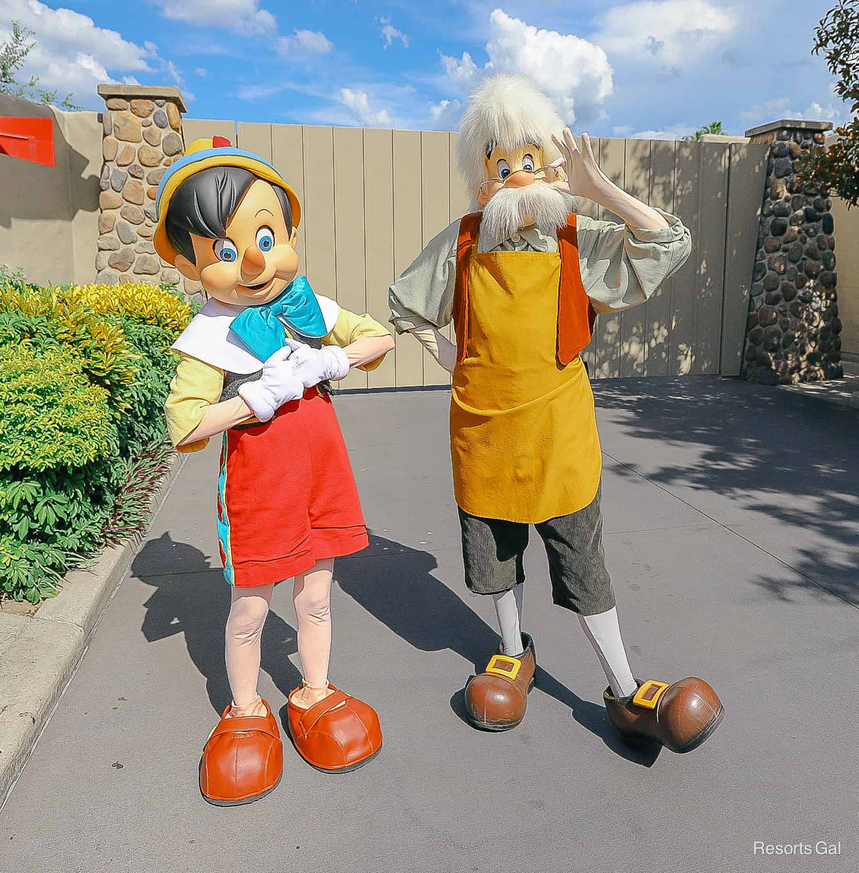 Pinocchio and Gepetto outside a fence near the entrance of Disney's Hollywood Studios 