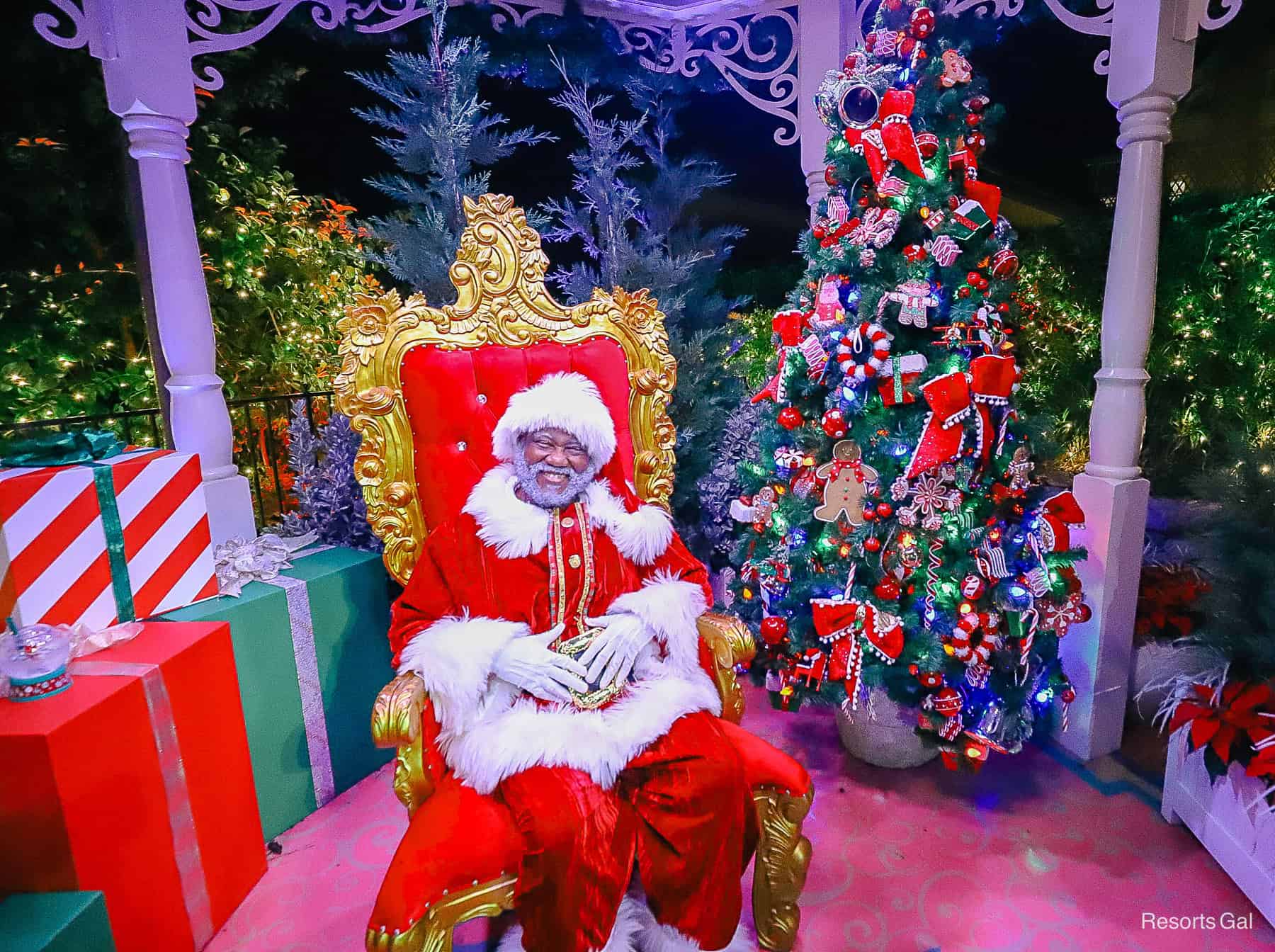 a Santa Claus sitting in the gazebo at Magic Kingdom 