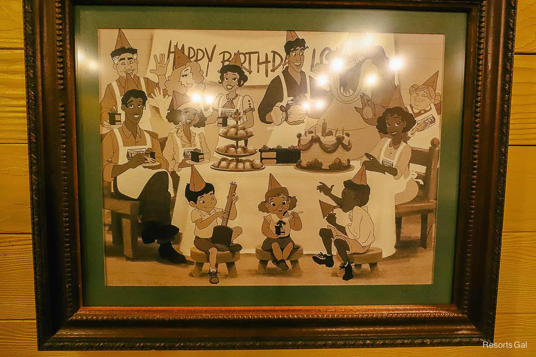a framed photo of a birthday party at Tiana's 