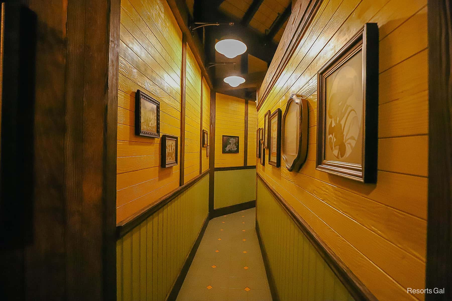 a hallway with family portraits and accolades 