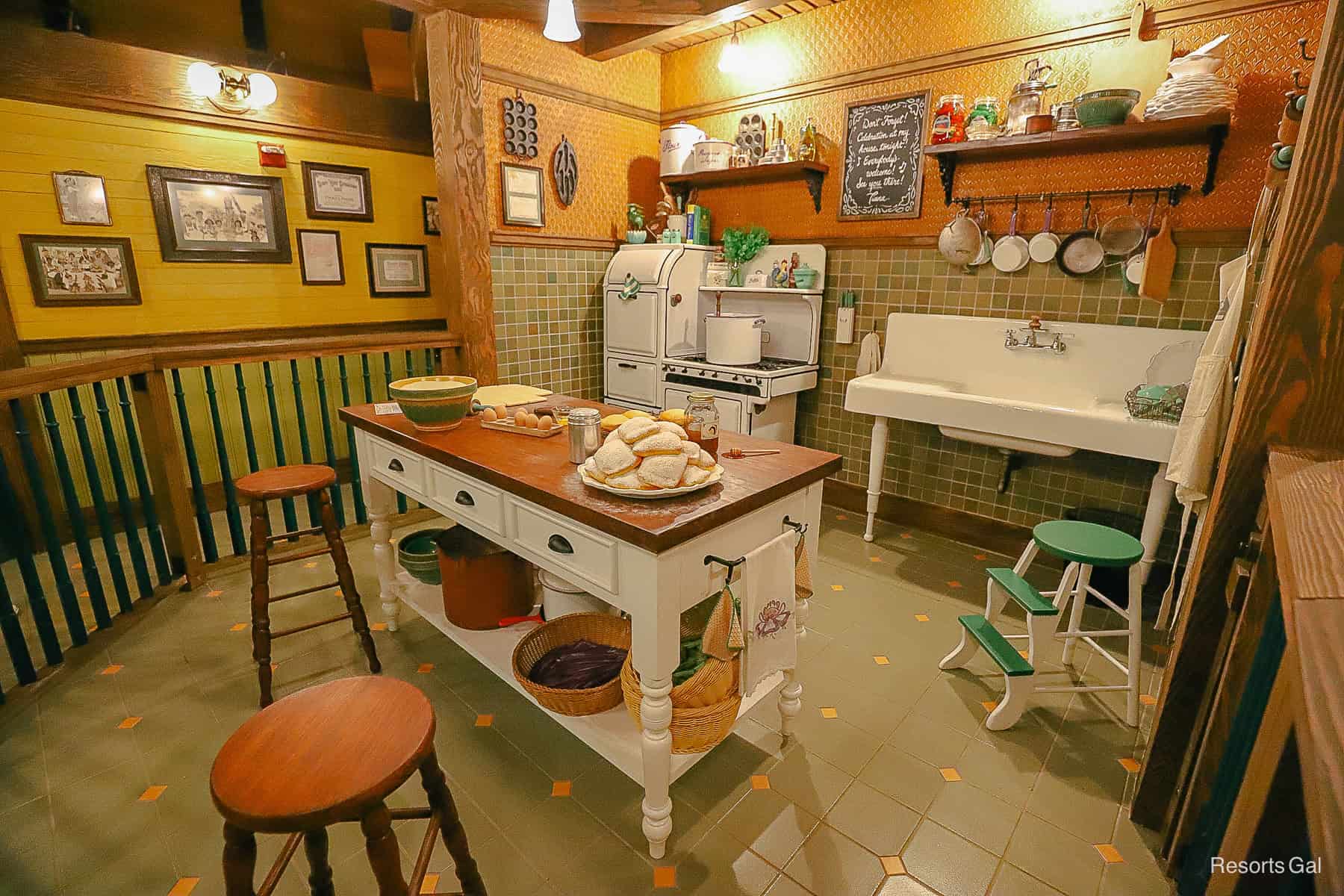 a kitchen with a platter of beignets on the counter 